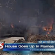 House burns to the ground as firefighters watch.